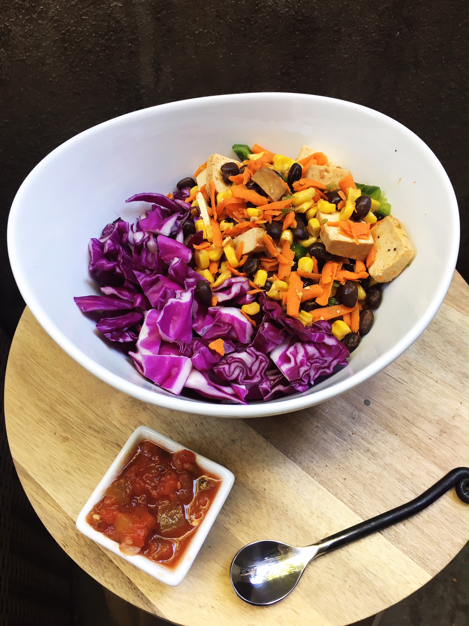 Big colorful bowl of veggies with a side of salsa